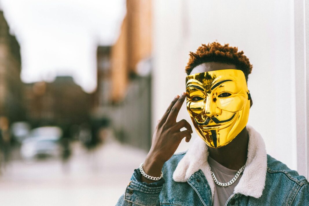 man wearing a gold mask